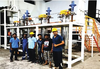 Erection team standing in front of a newly assembled extraction skid at a customer site.